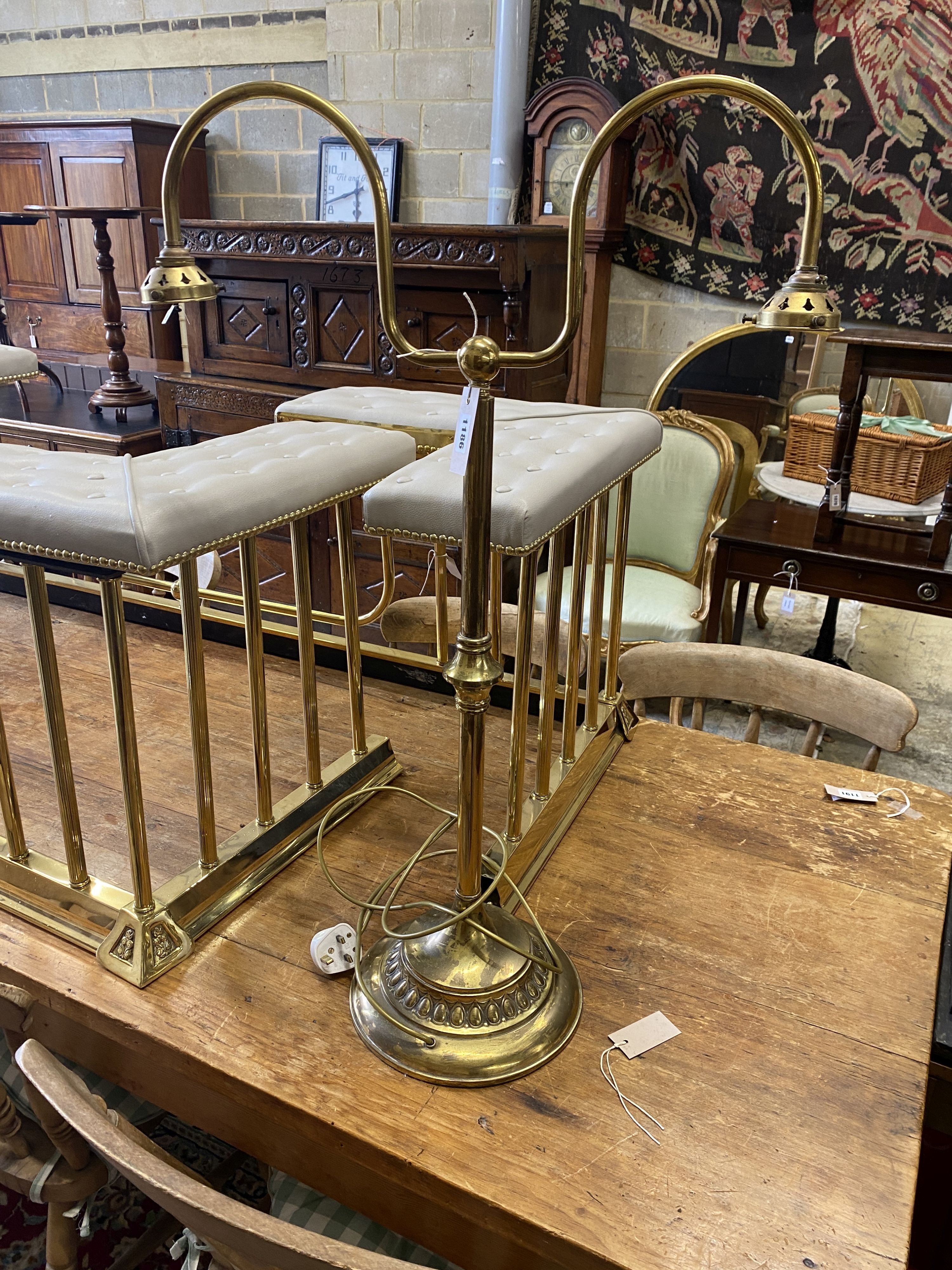 An early 20th century lacquered brass twin branch reading light with blue glass shades, height 86cm